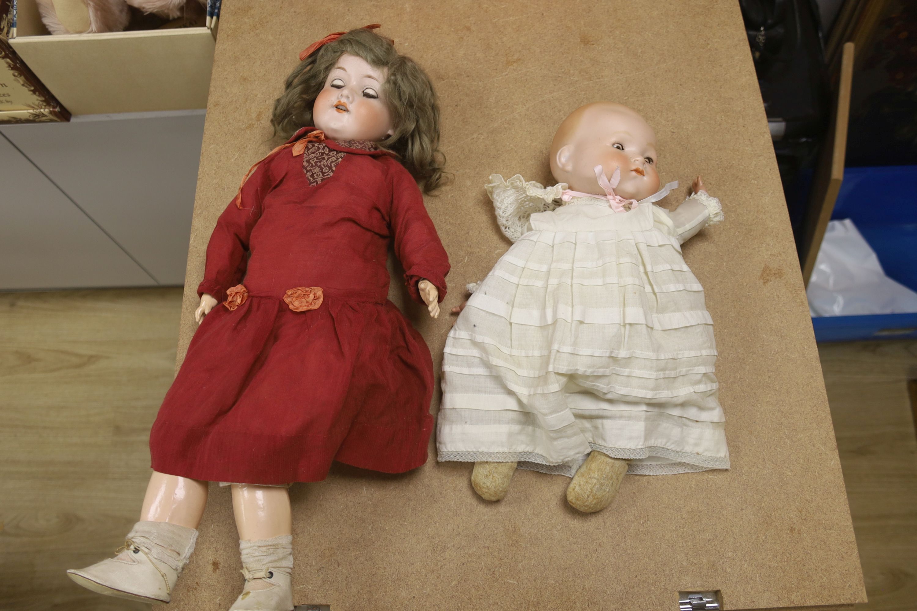 Armand Marseille bisque doll, 390 A5M, with sleeping eyes and open mouth and a similar baby doll